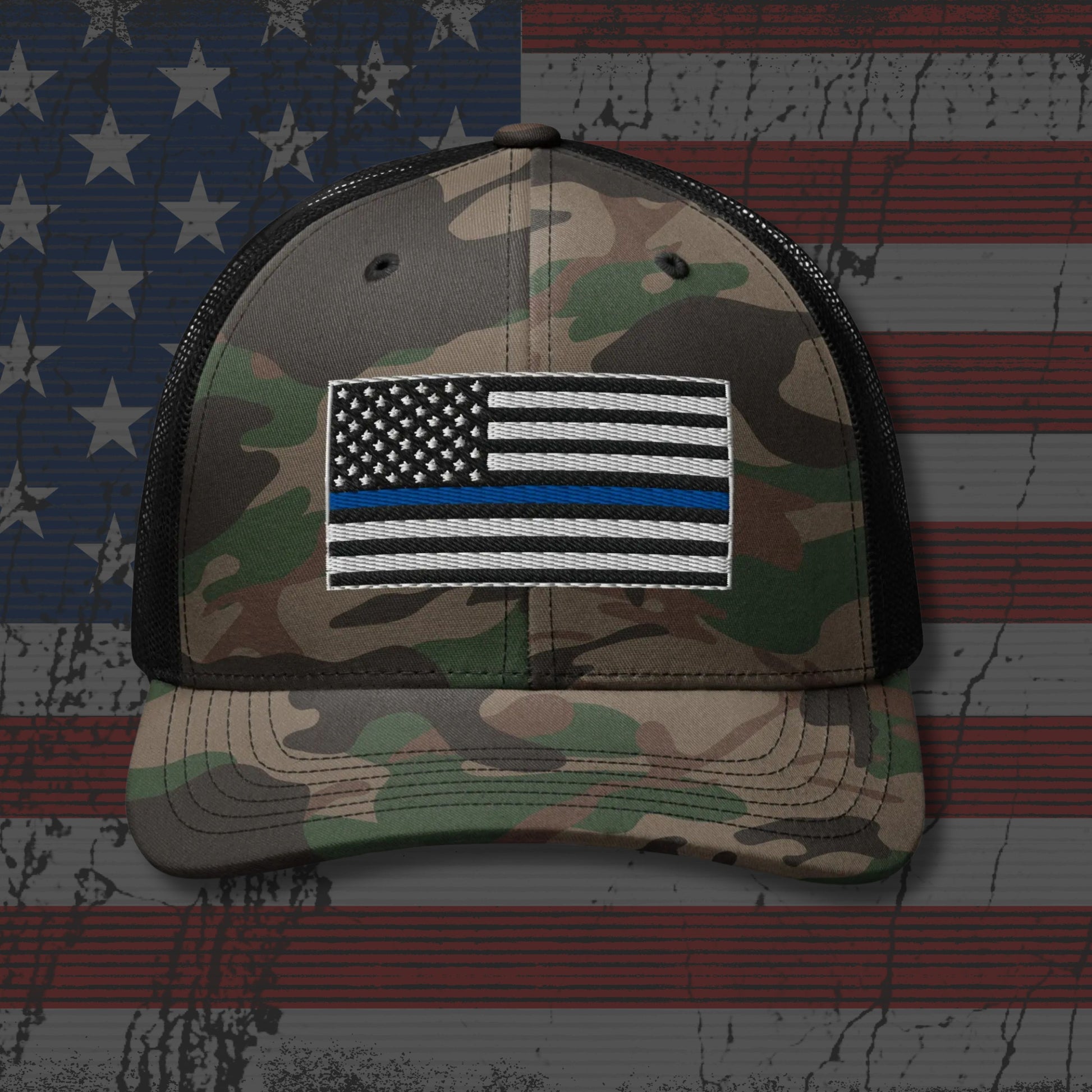 Camouflage cap with a flag patch on an American flag background