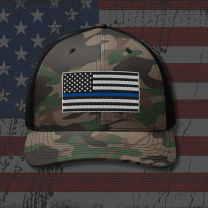 Camouflage cap with a flag patch on an American flag background