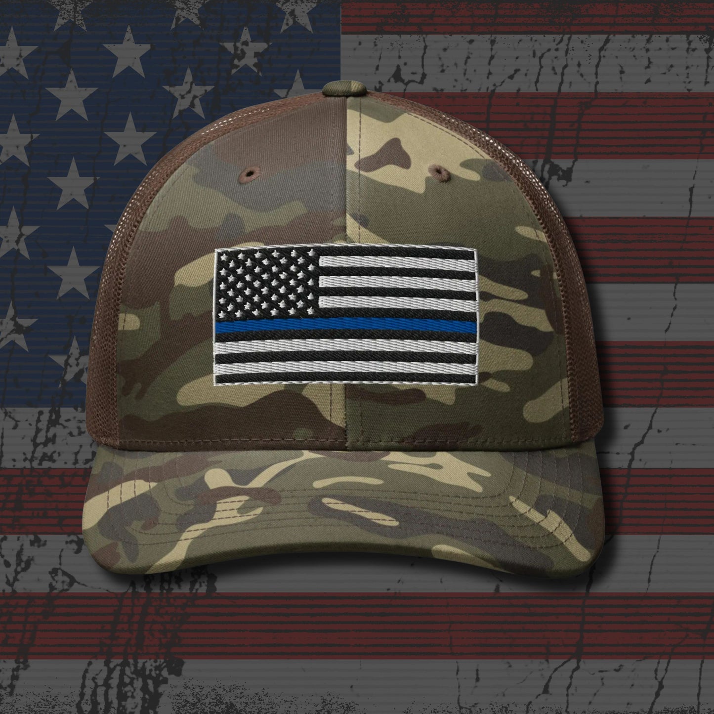 Camouflage cap with a Thin Blue Line patch on an American flag background