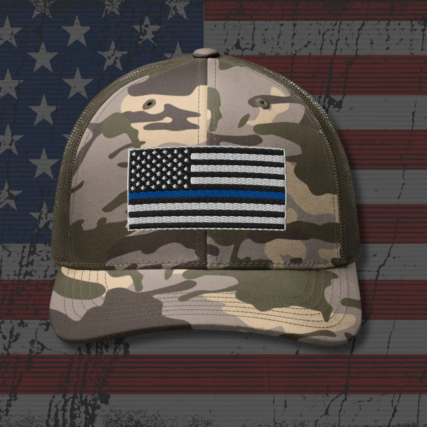 Camouflage cap with a flag patch on an American flag background