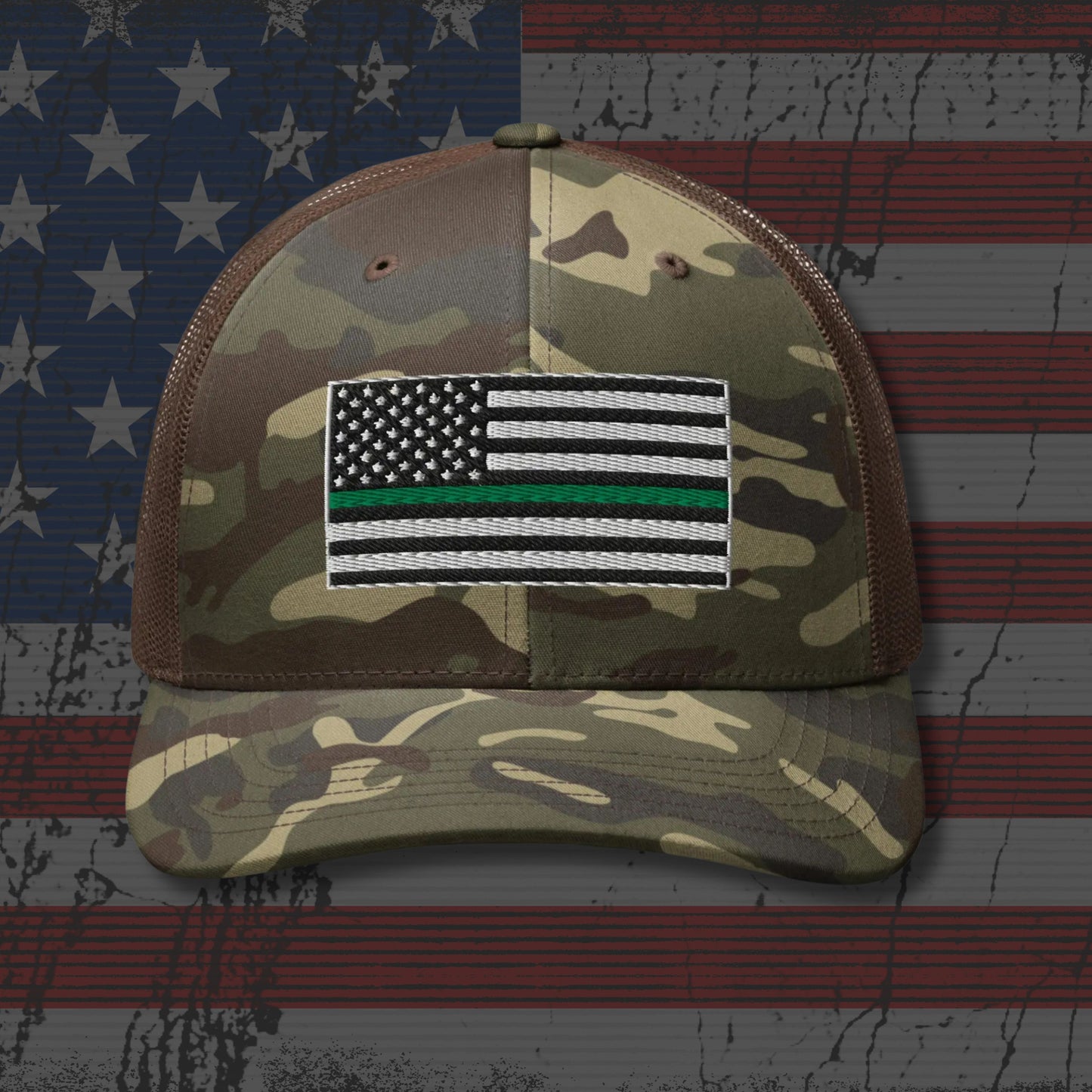 Camouflage cap with a flag patch on an American flag background