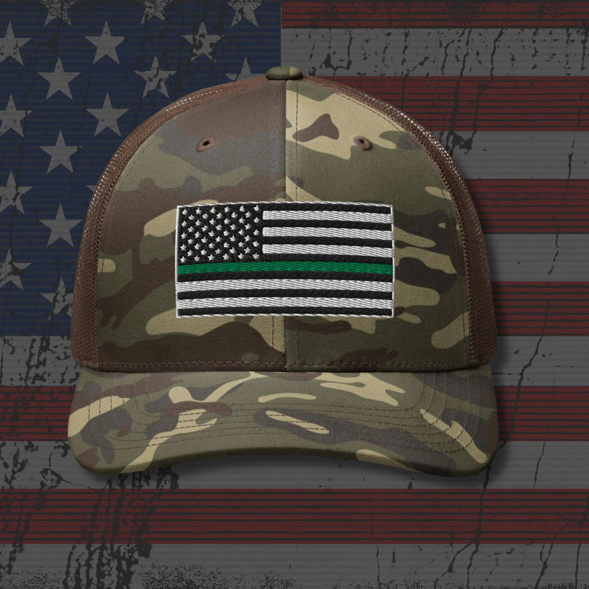 Camouflage cap with a flag patch on an American flag background