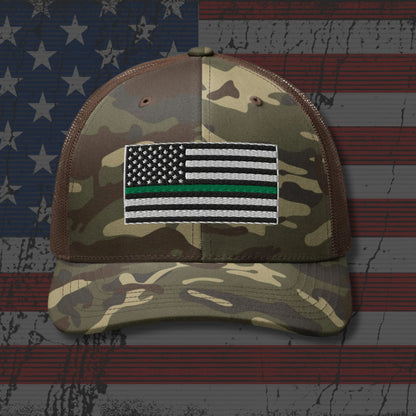 Camouflage cap with a flag patch on an American flag background
