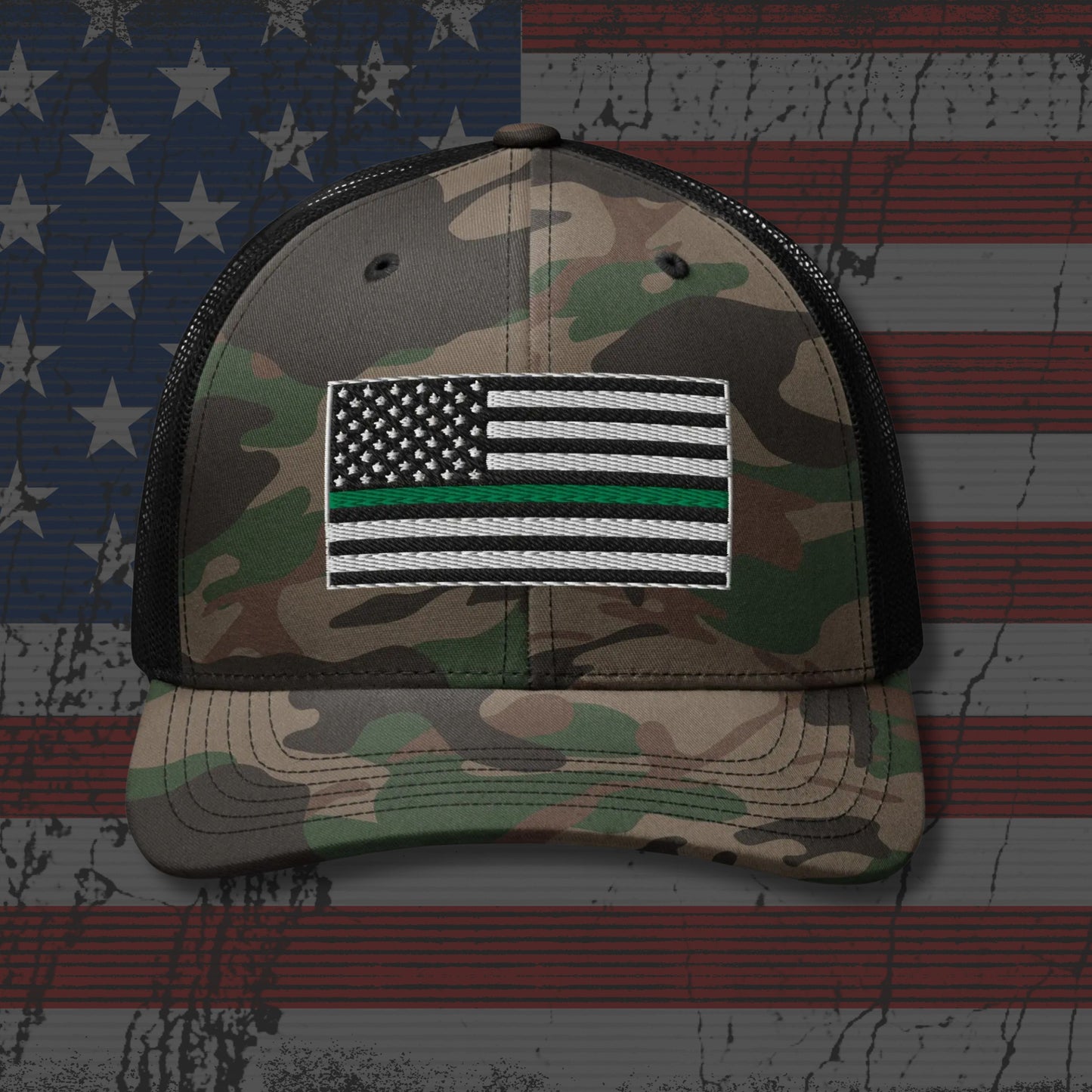Camouflage cap with American flag patch on an American flag background