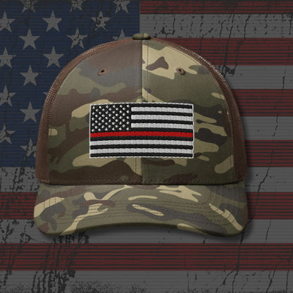 Camouflage cap with a Thin Red Line flag patch on an American flag background