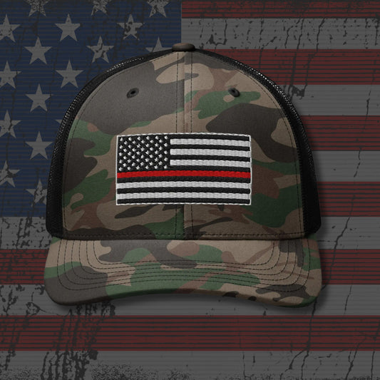 Camouflage cap with a Thin Red Line flag patch on an American flag background