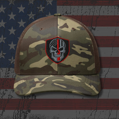 Camouflage cap with a skull and crossbones patch on an American flag background