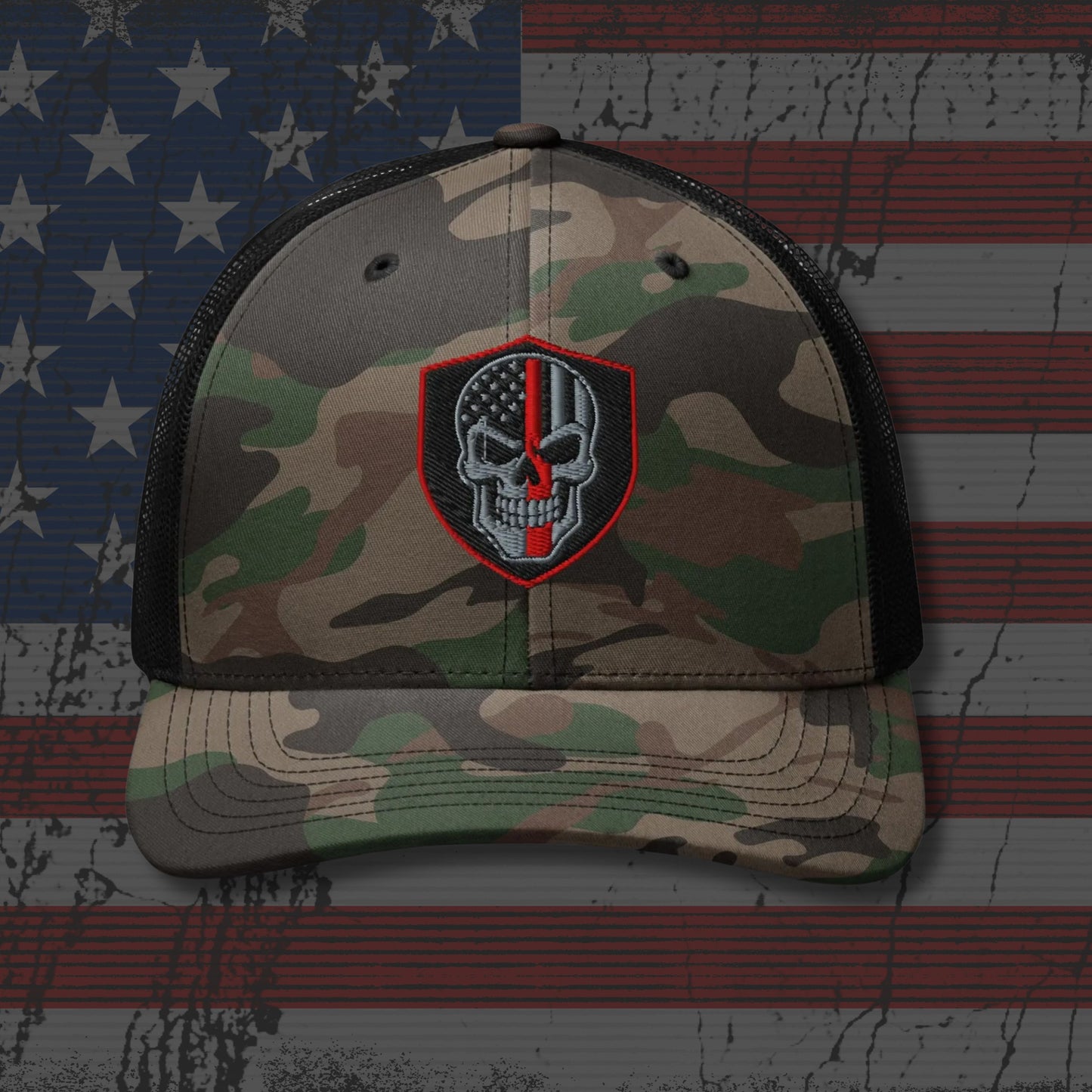 Camouflage cap with a skull and crossbones patch on an American flag background
