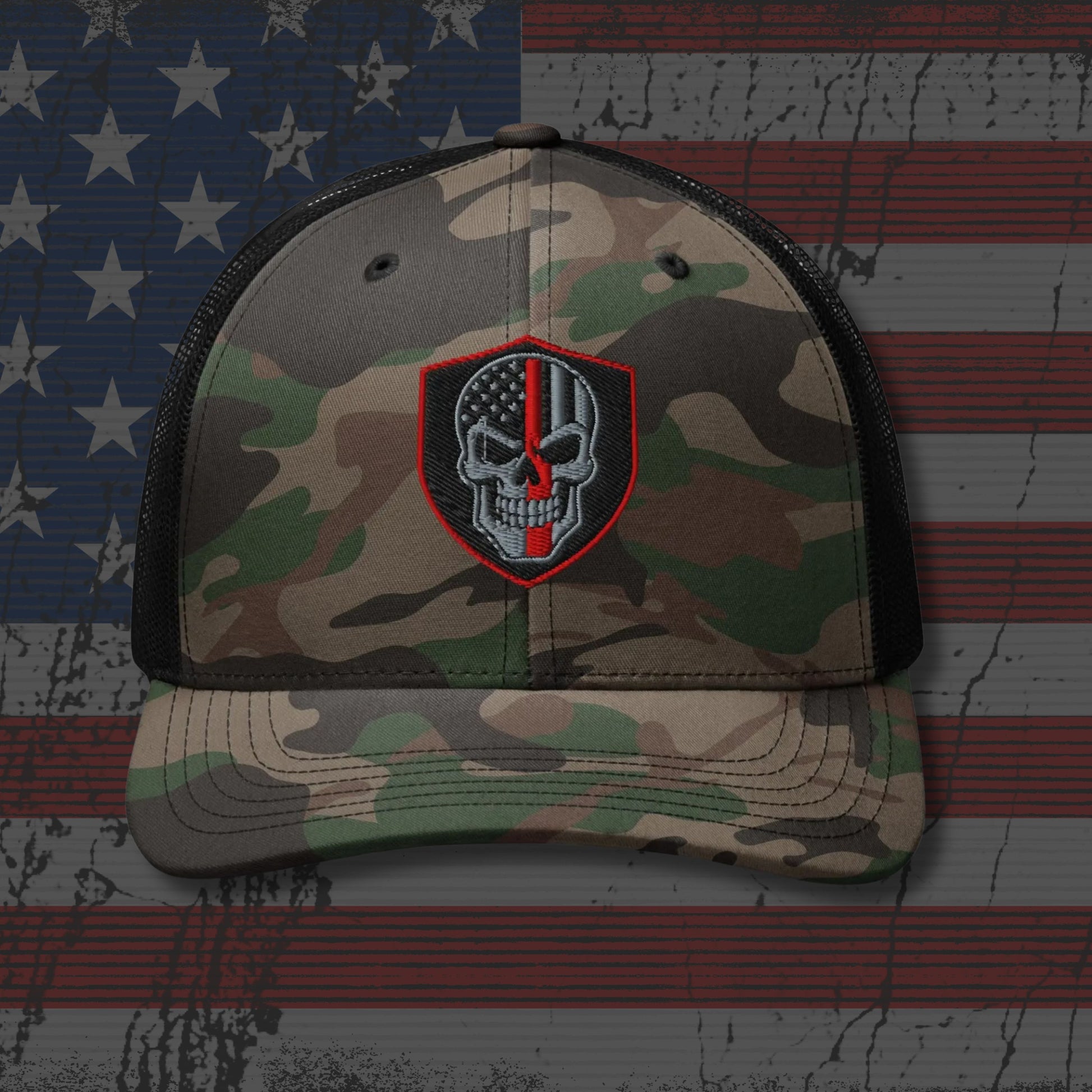 Camouflage cap with a skull and crossbones patch on an American flag background