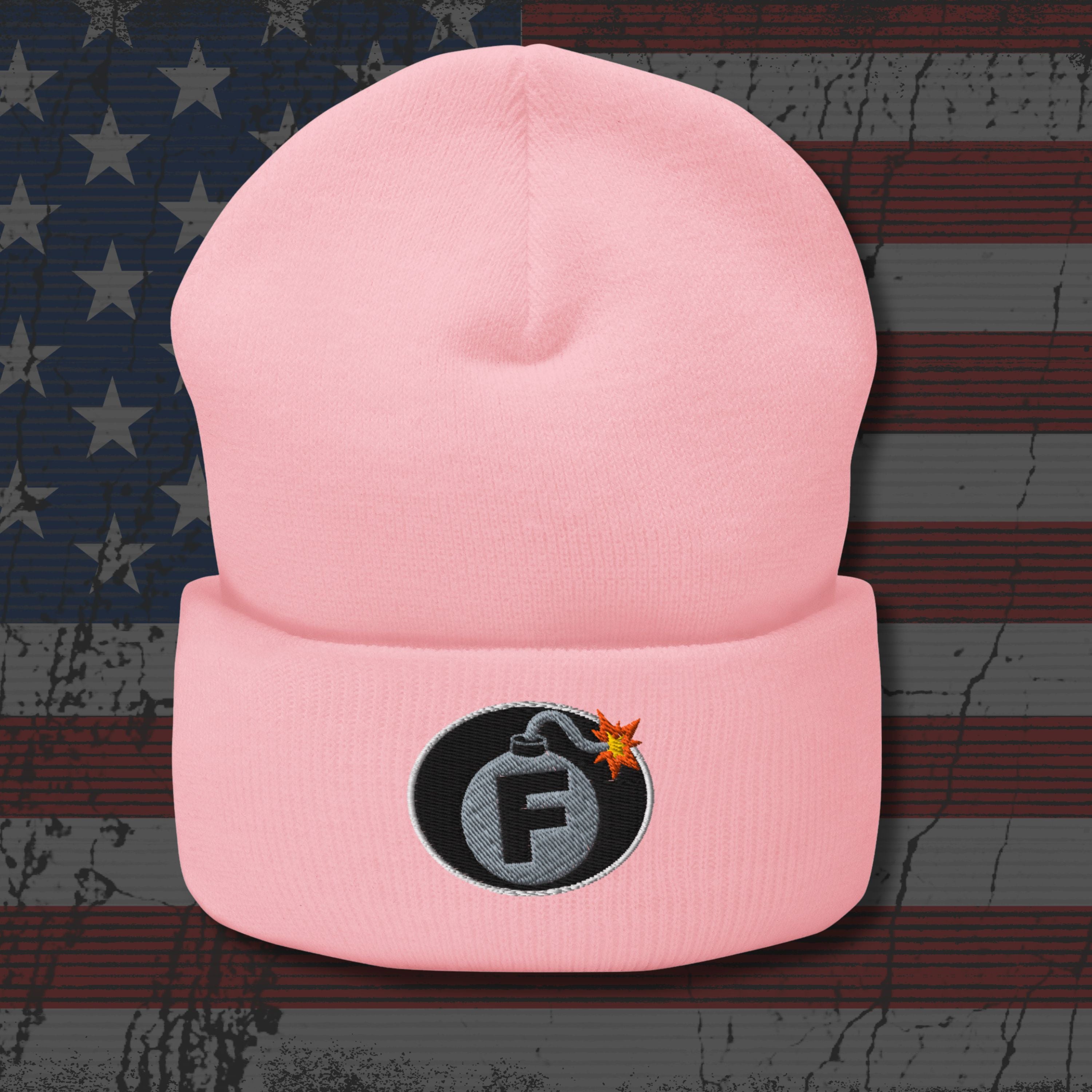 Pink beanie with a bomb-themed patch featuring the letter 'F' on an American flag background.