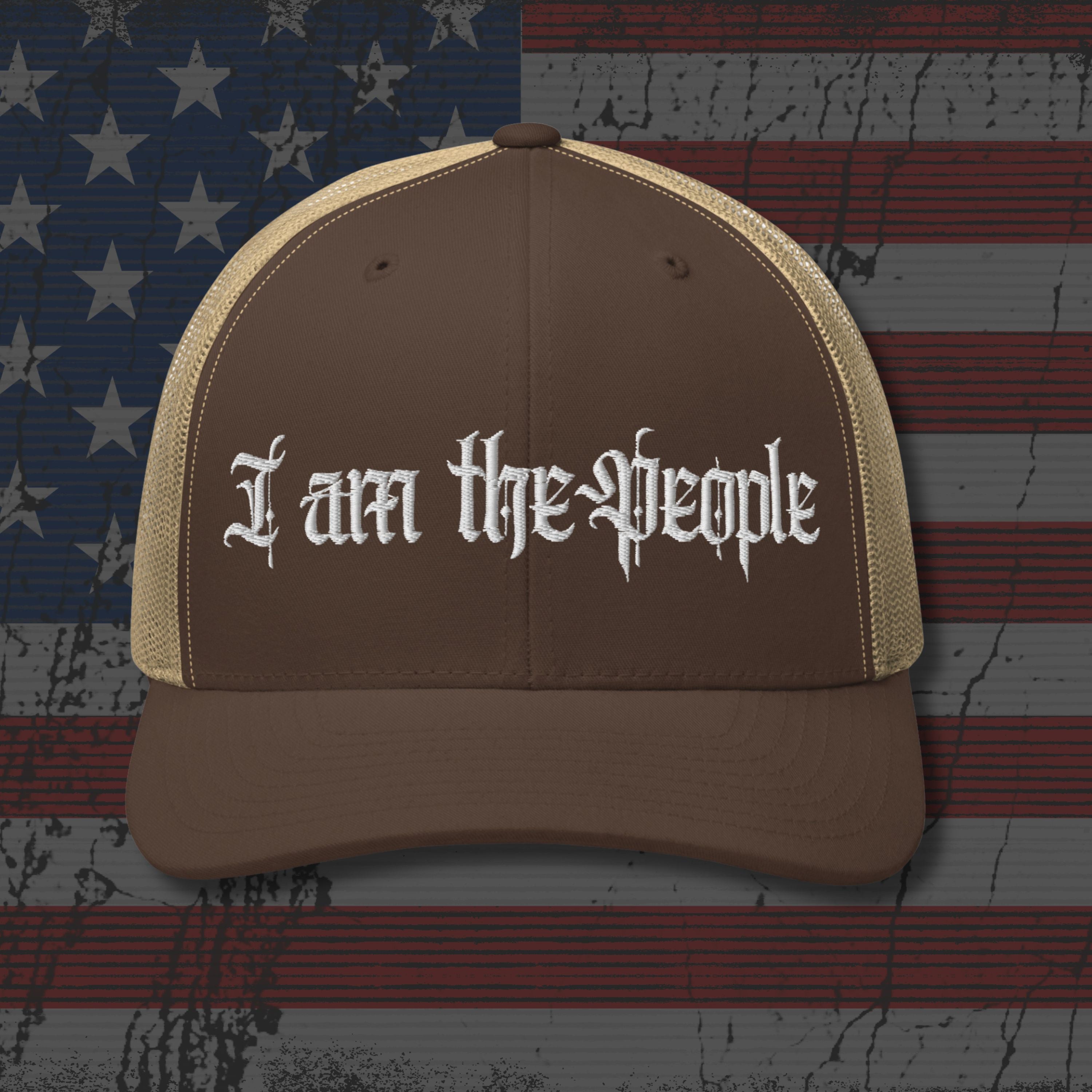 Brown cap with 'I am the People' text on an American flag background
