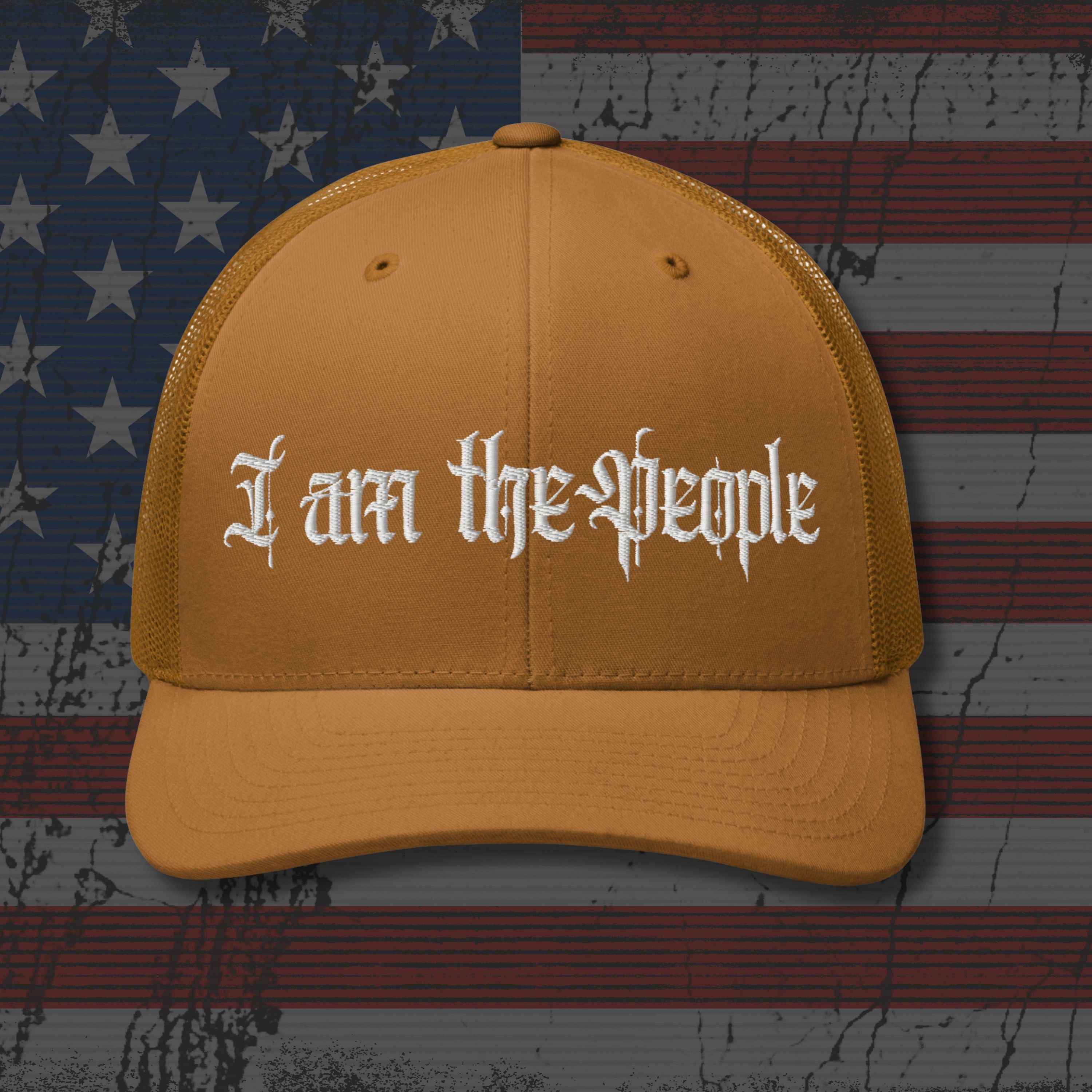 Brown cap with 'I am the People' text on an American flag background