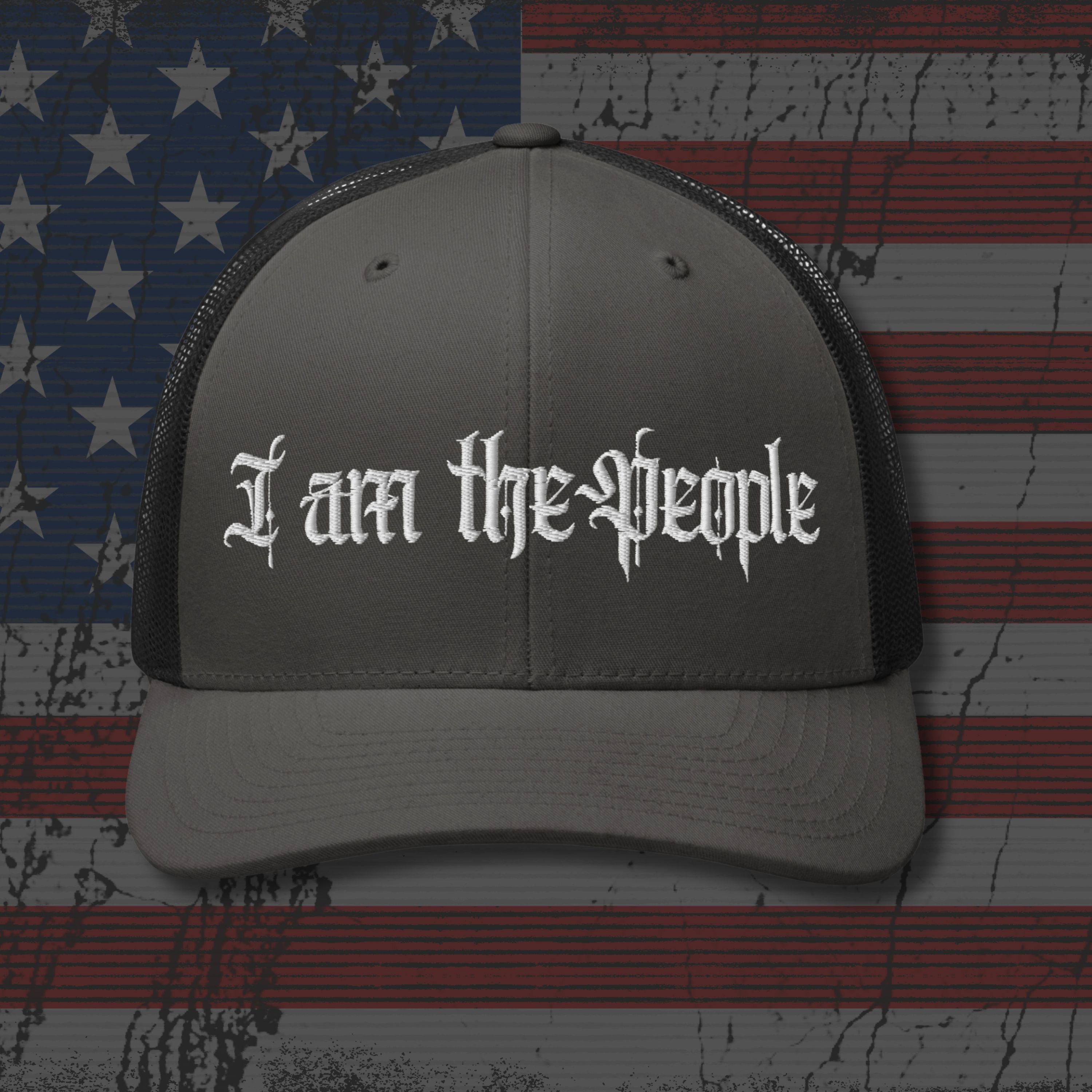 Gray cap with 'I am the People' text on an American flag background