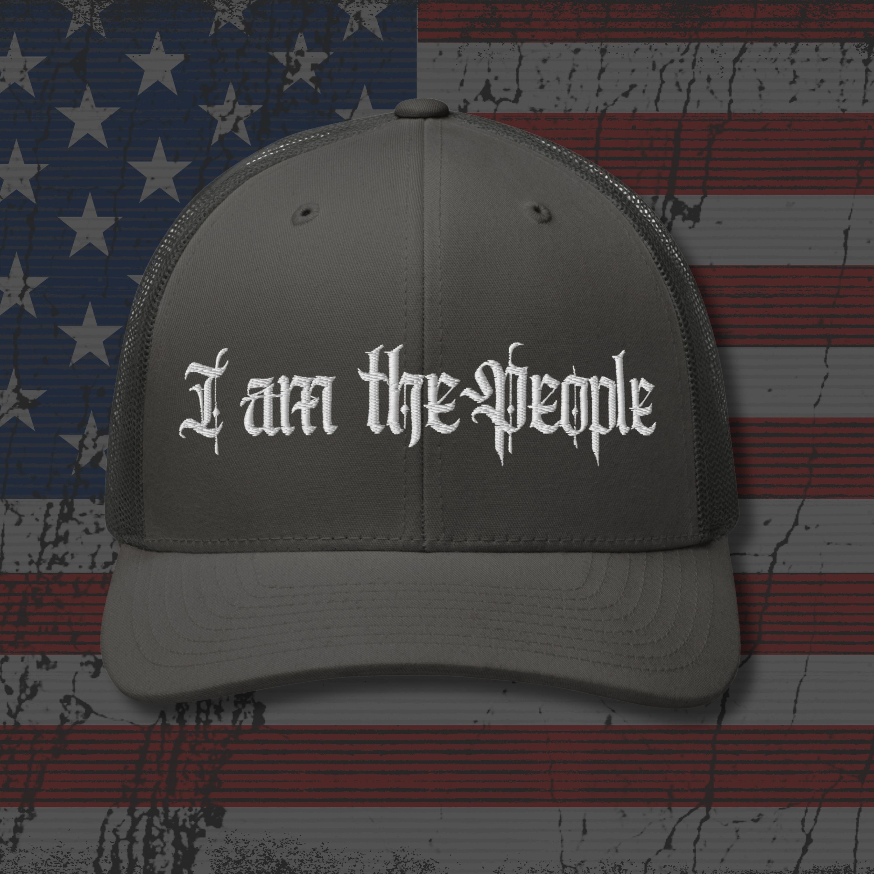 Gray cap with 'I am the People' text on an American flag background