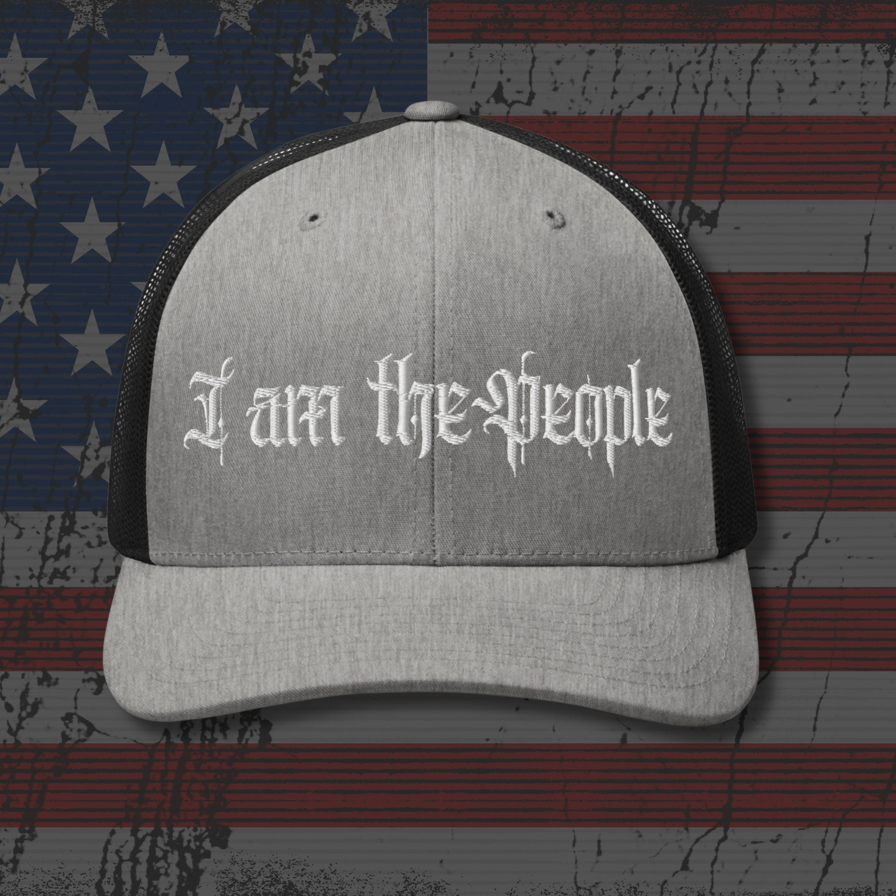Gray and black cap with 'I am the People' text on an American flag background