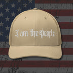 Beige cap with 'I am the People' text on an American flag background