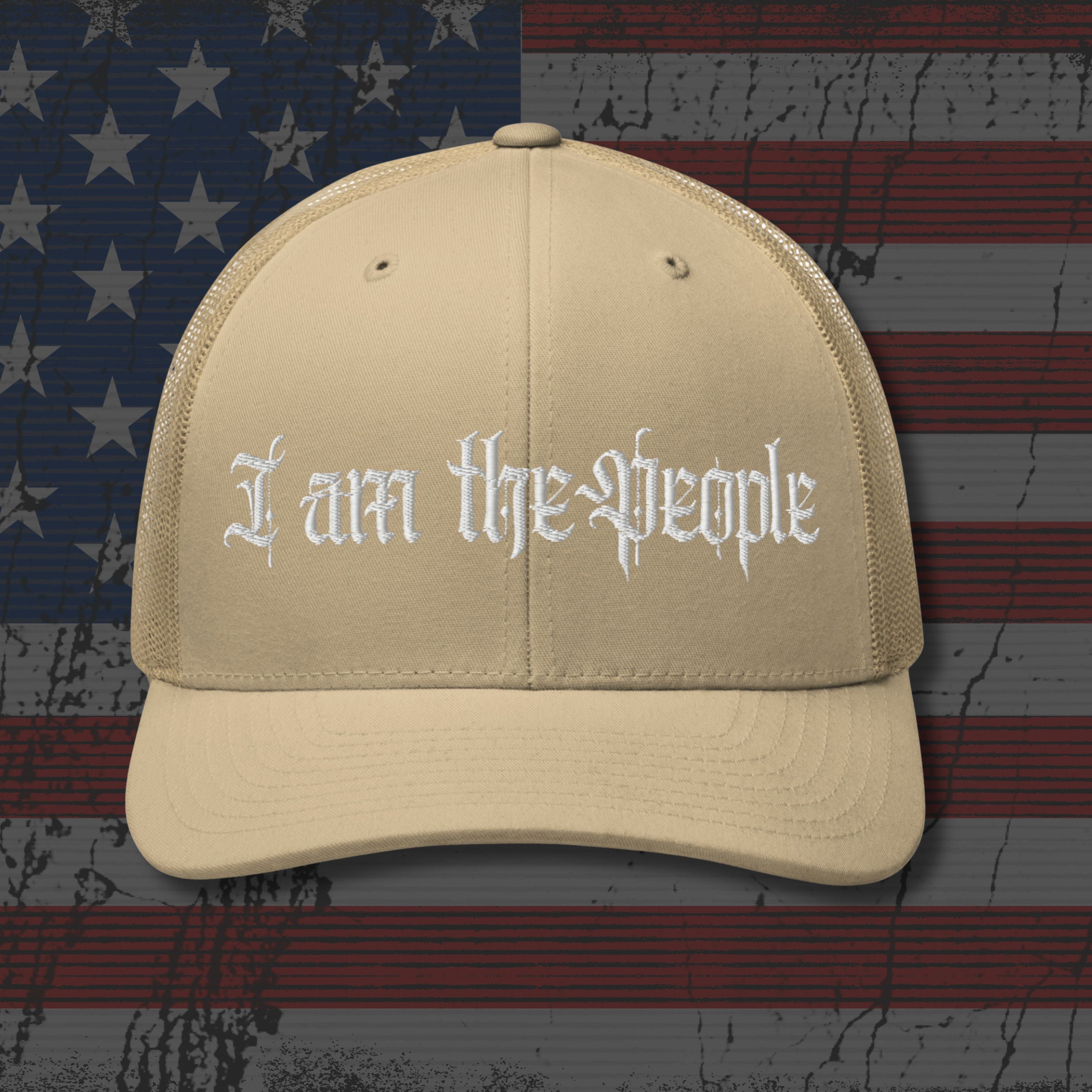 Beige cap with 'I am the People' text on an American flag background