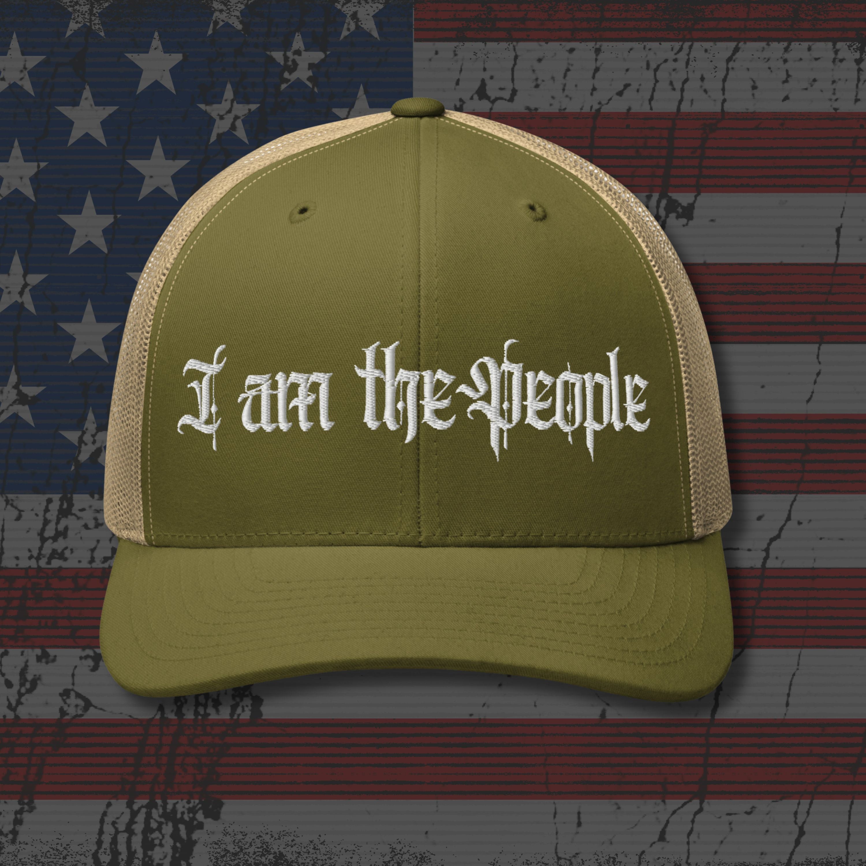 Green cap with 'I am the People' text on an American flag background