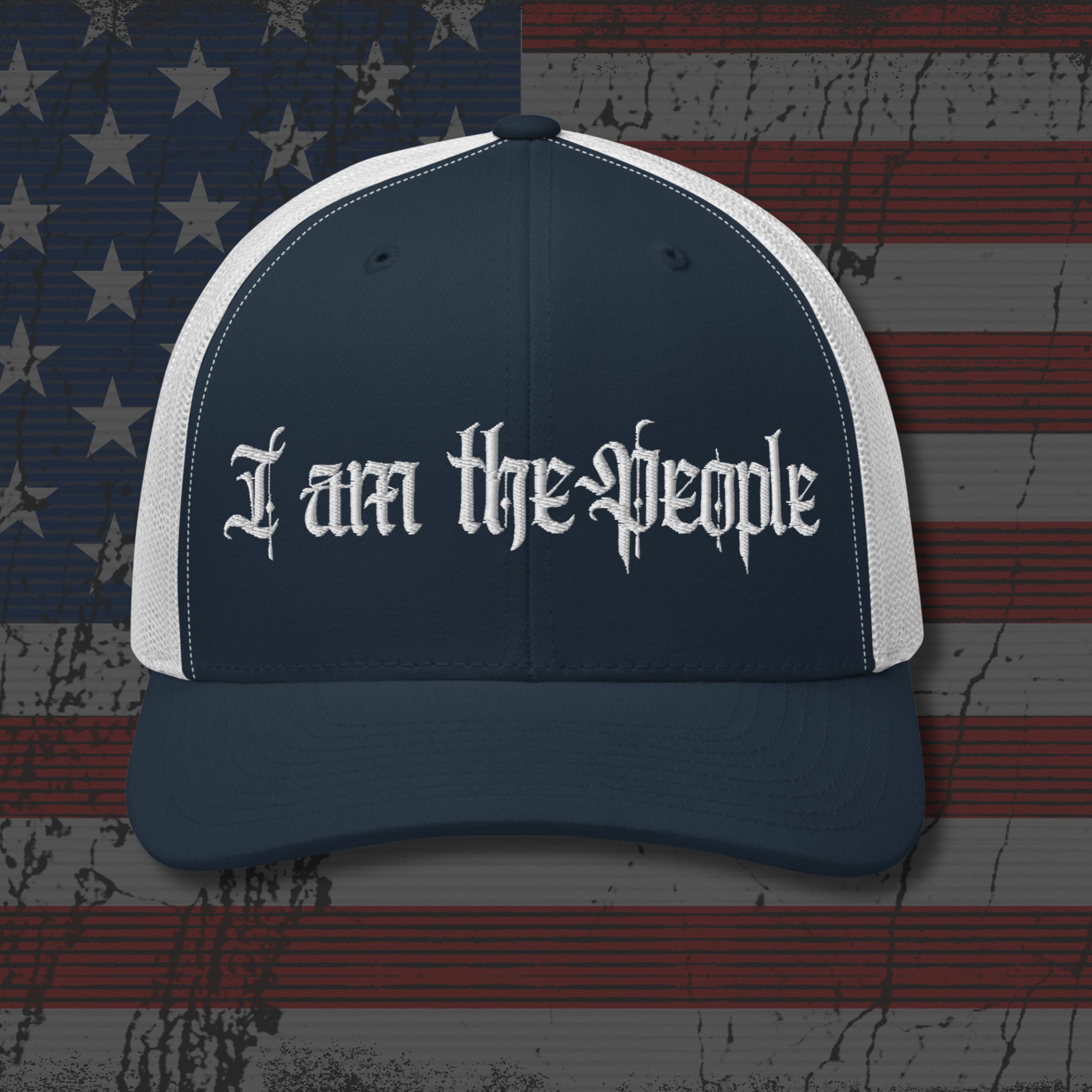 Navy and white cap with 'I am the People' text on an American flag background