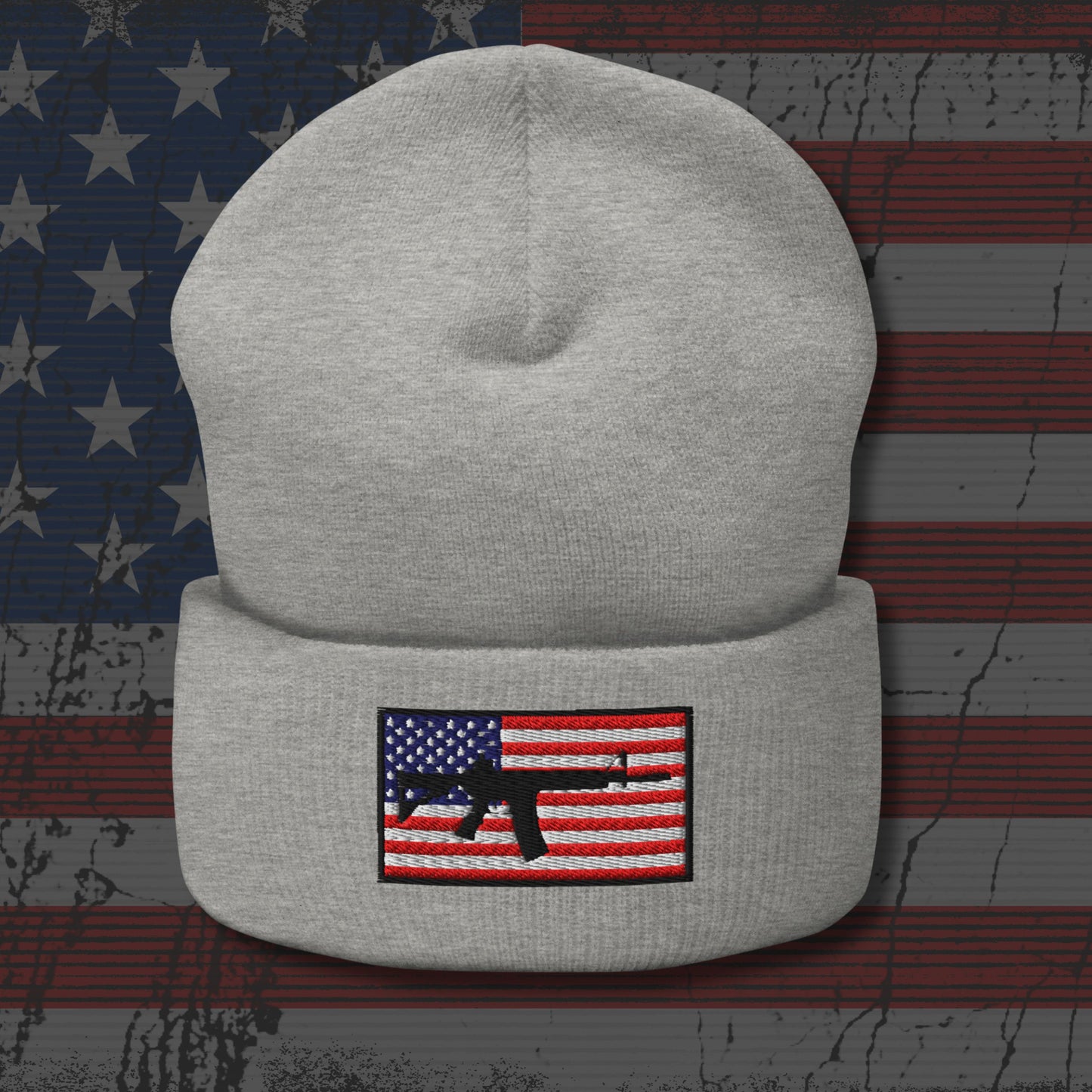 Gray beanie with American flag and gun patch on a distressed American flag background