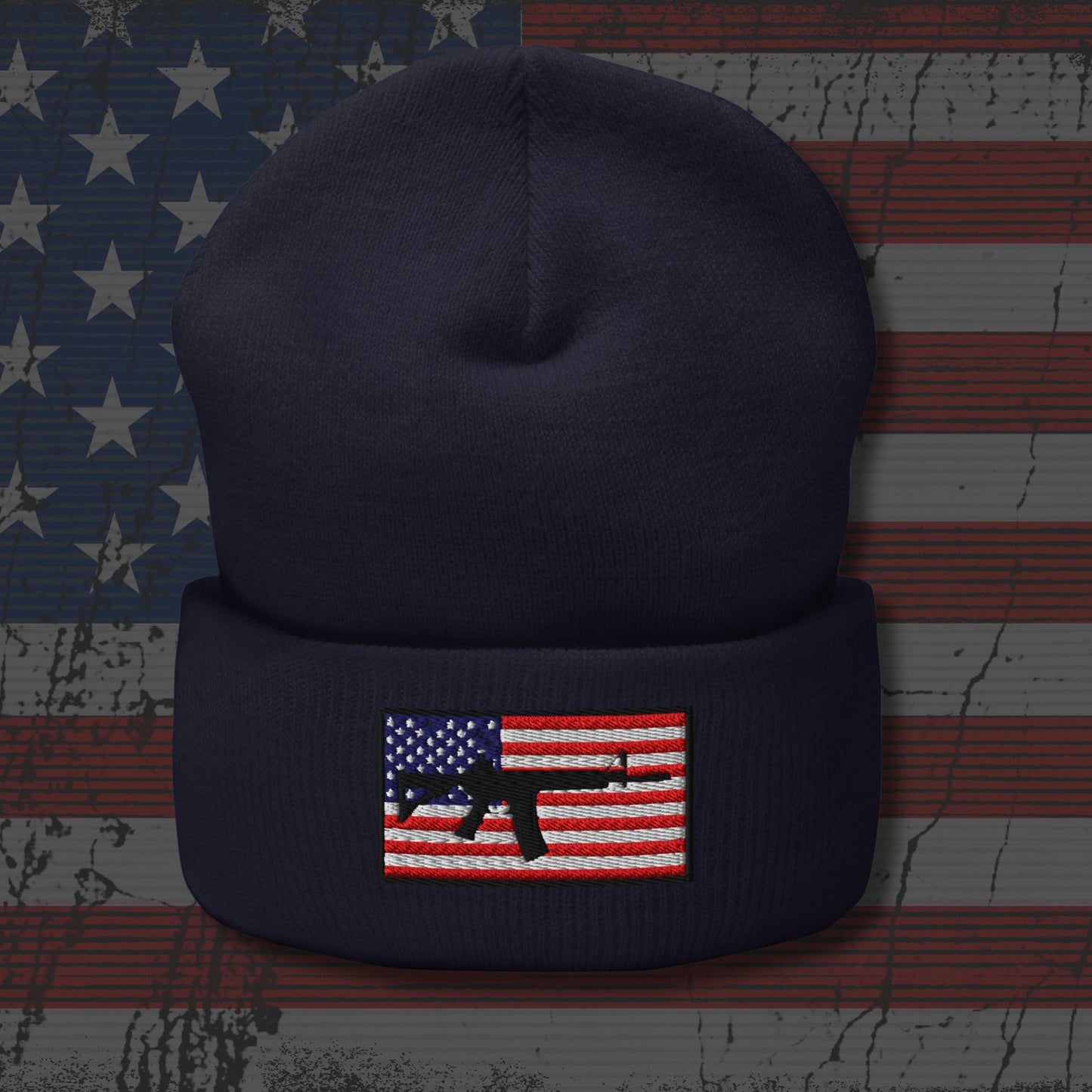 Navy blue beanie with American flag and rifle patch on a distressed American flag background