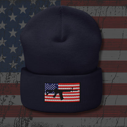 Navy blue beanie with American flag and rifle patch on a distressed American flag background