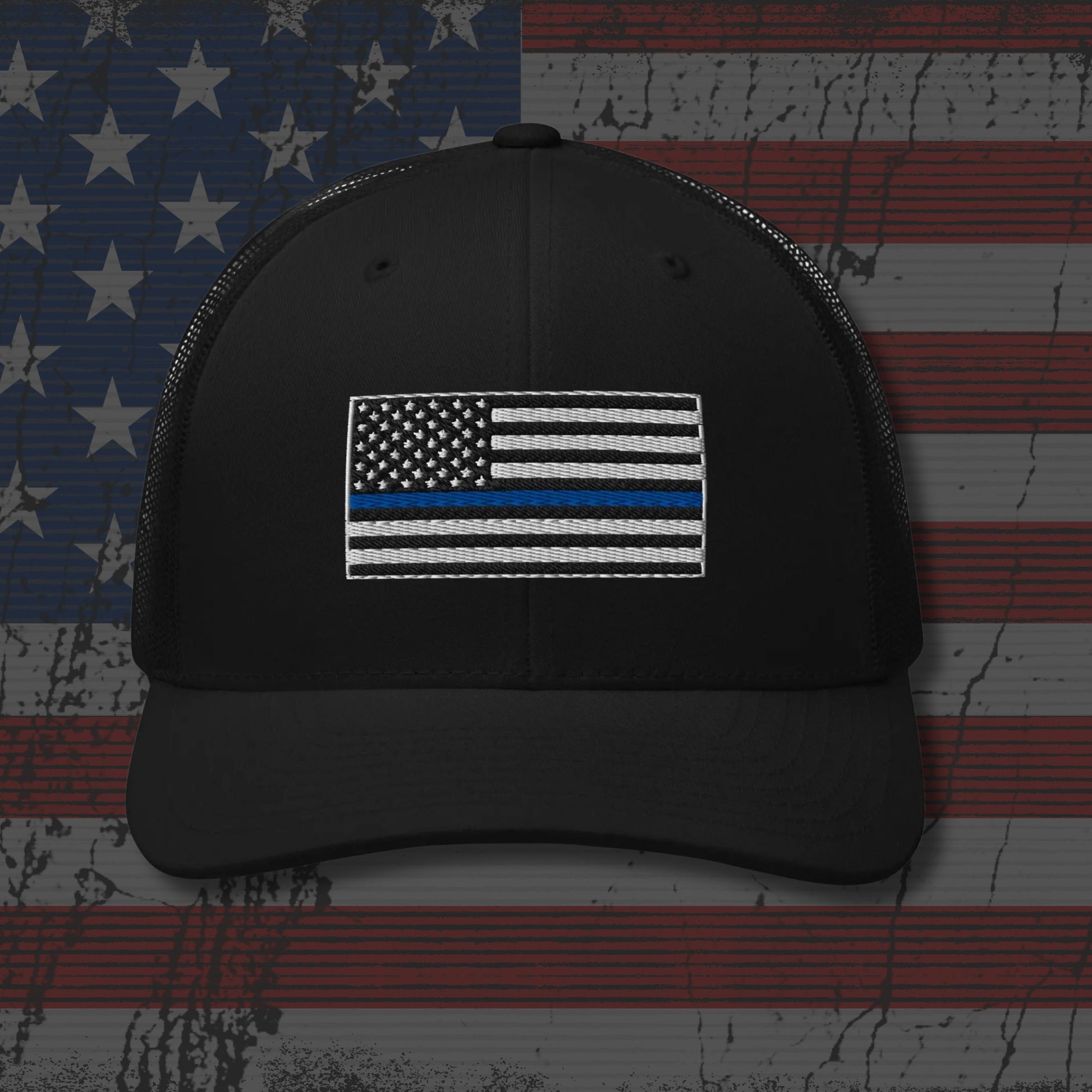 Black cap with American flag patch on a distressed American flag background
