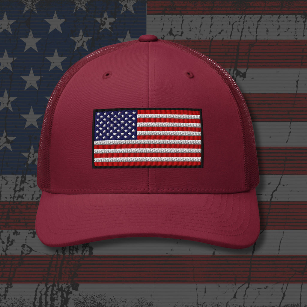 Red cap with American flag patch on a distressed American flag background