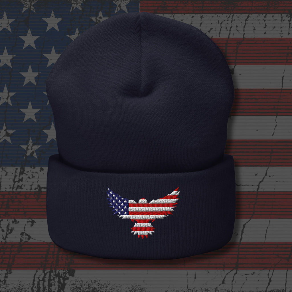 Navy blue beanie with an embroidered American flag eagle design on a textured American flag background.