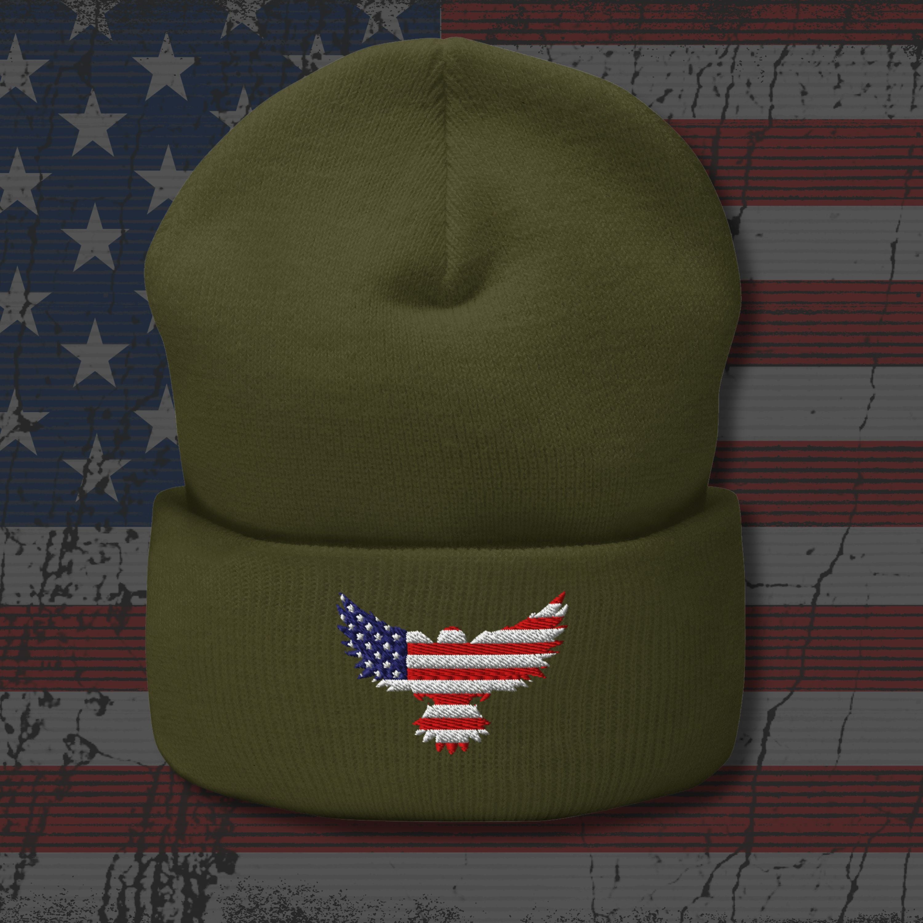 Green beanie with an embroidered American flag eagle design on a textured American flag background.