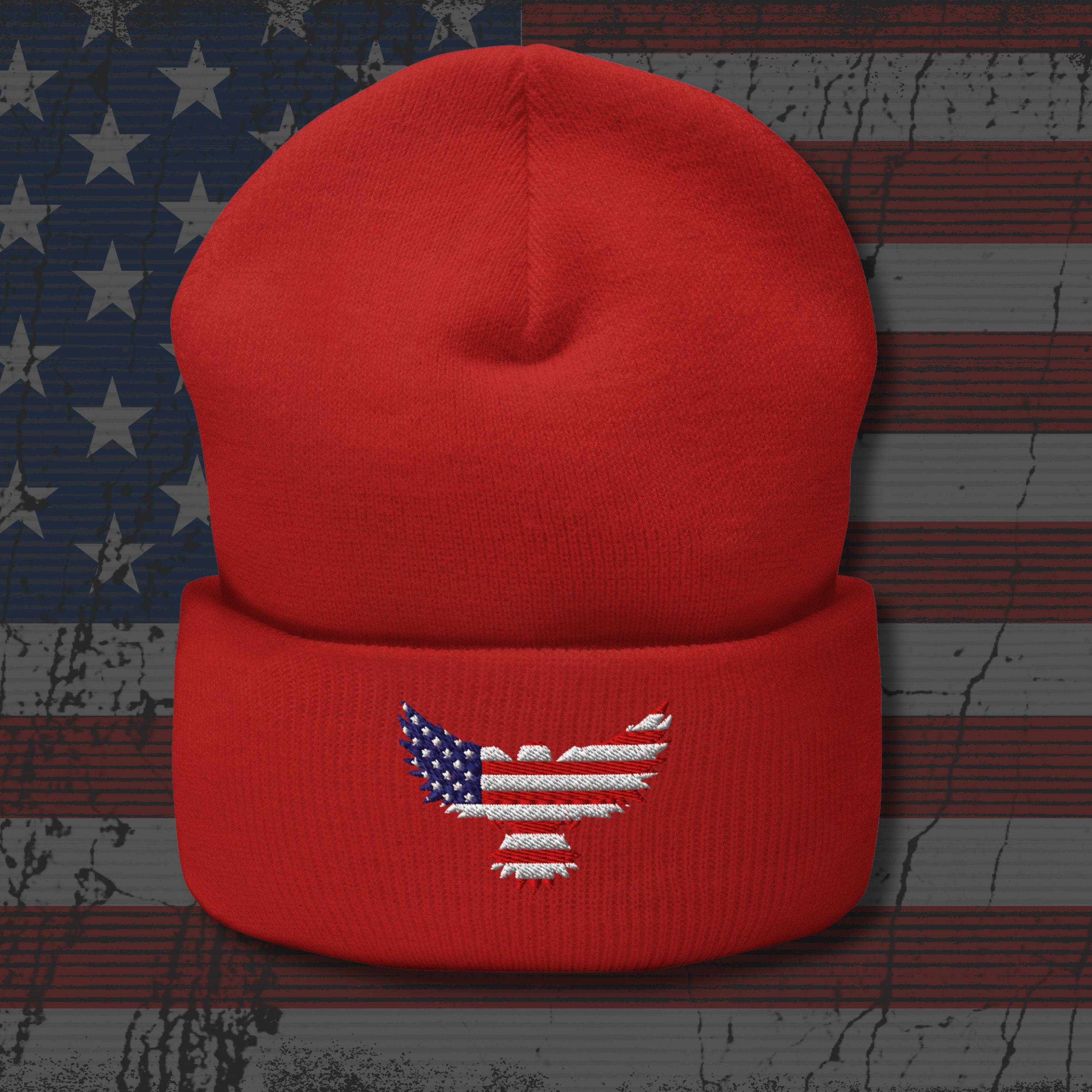Red beanie with an embroidered eagle design on a distressed American flag background