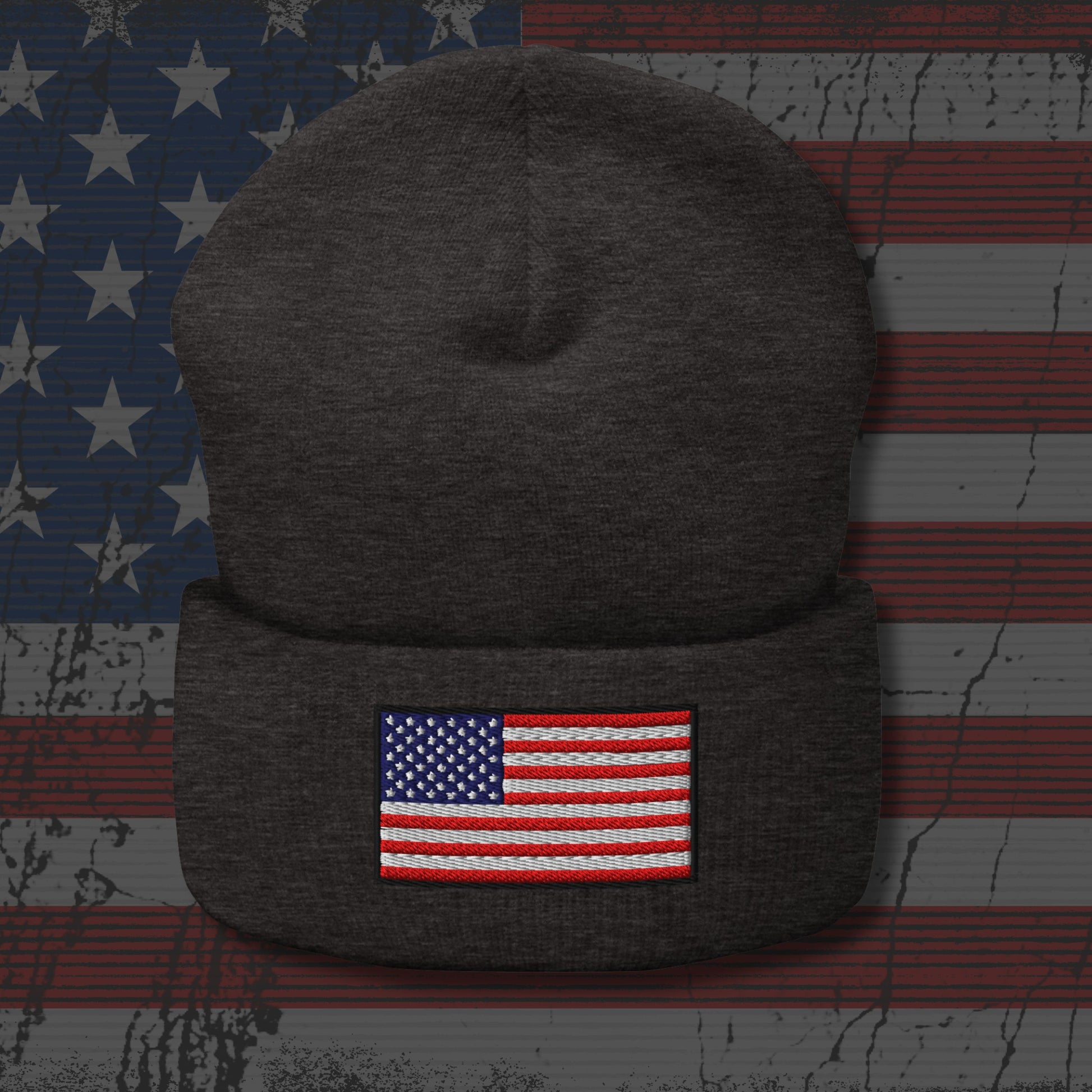 Dark gray beanie with American flag patch on a distressed American flag background