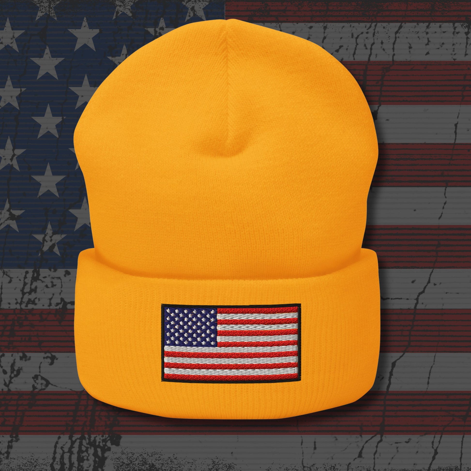 Yellow beanie with American flag patch on a distressed American flag background