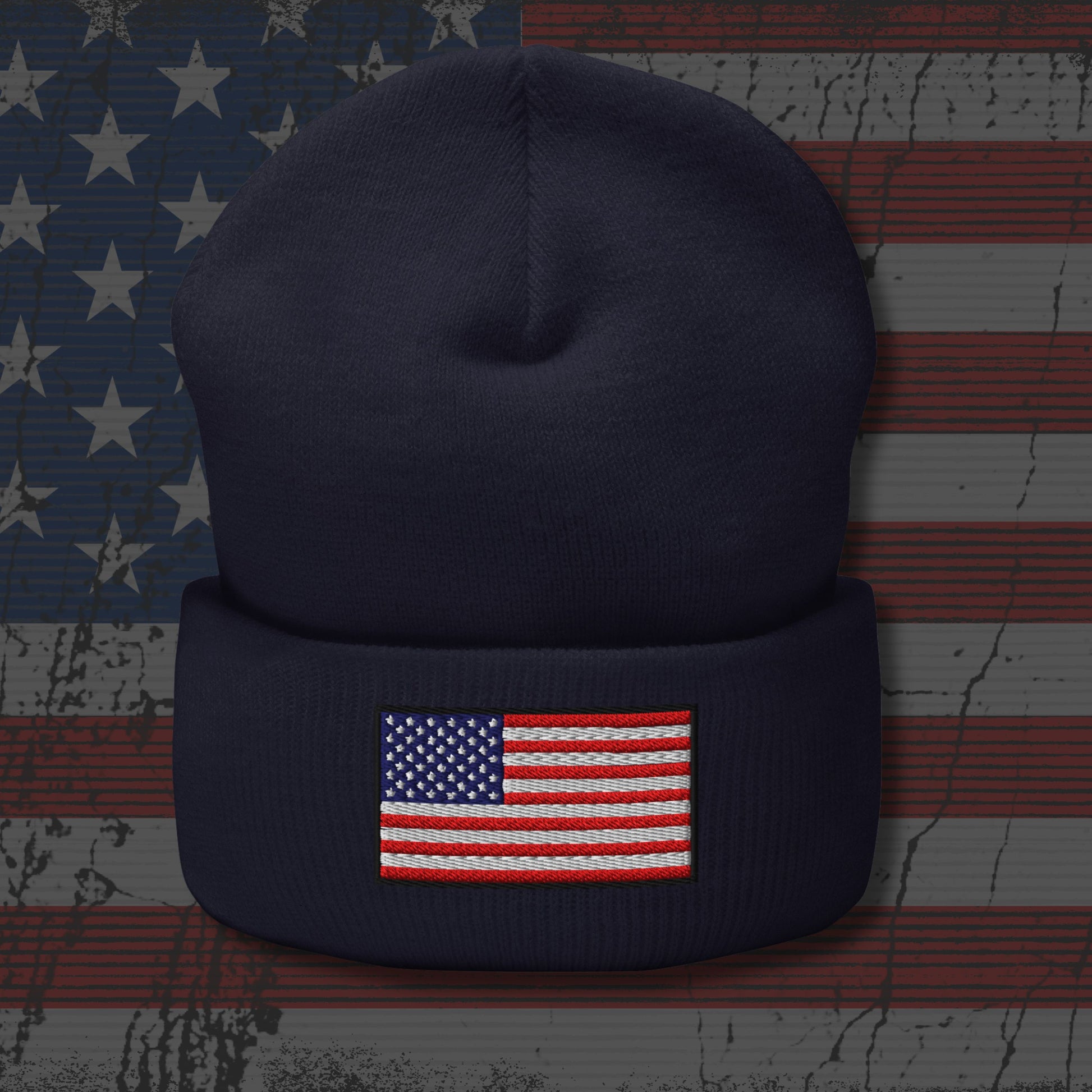 Navy blue beanie with American flag patch on a textured American flag background