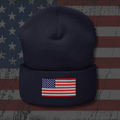 Navy blue beanie with American flag patch on a textured American flag background