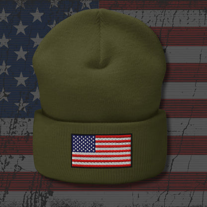 Green beanie with American flag patch on a background resembling an American flag.