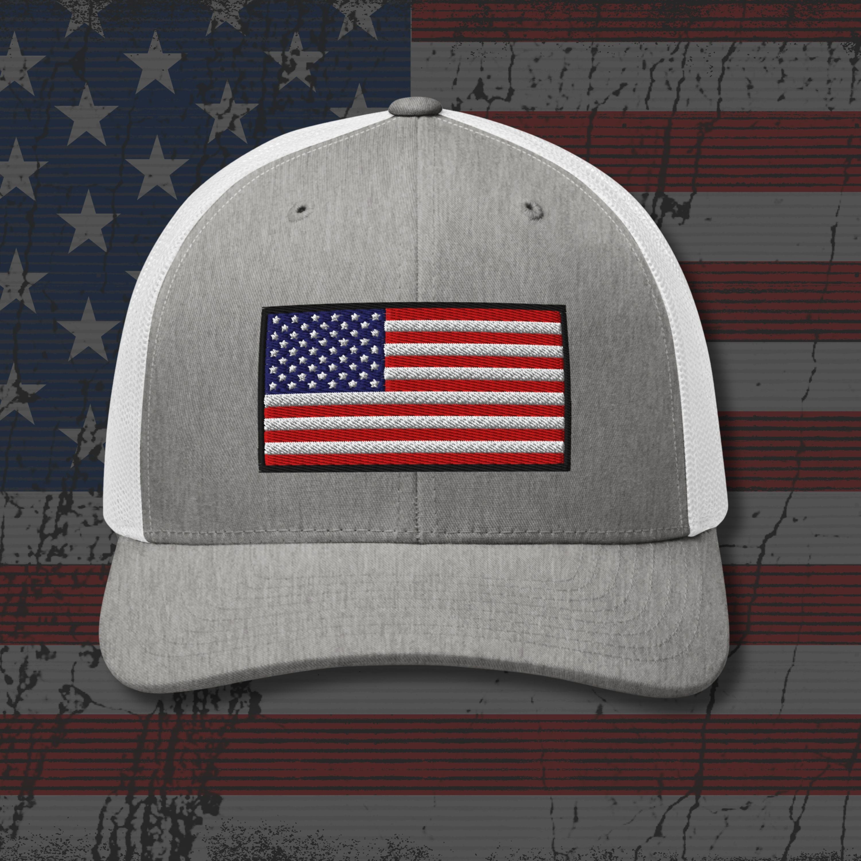 Gray and white cap with American flag patch on a distressed American flag background