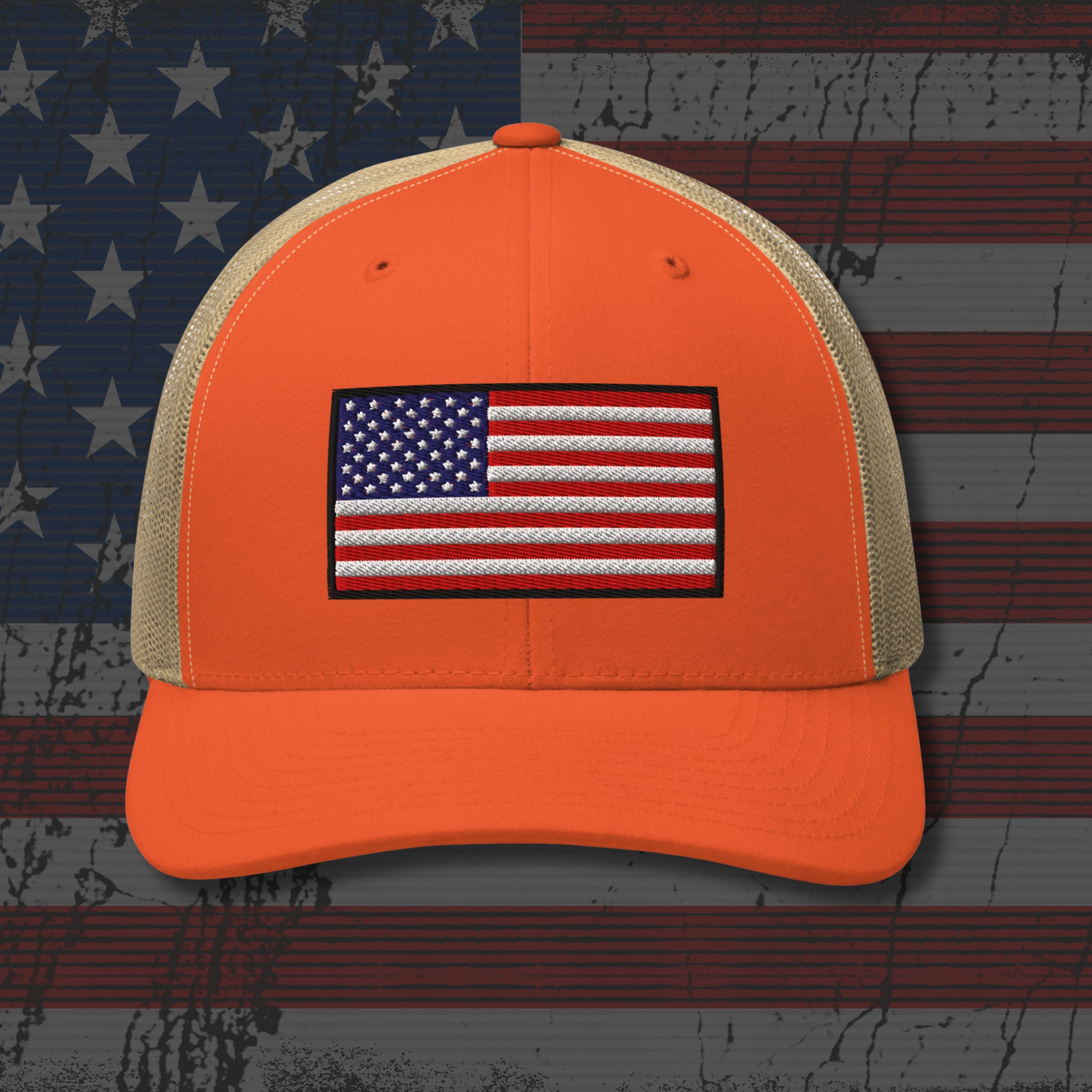 Orange cap with American flag patch on a background resembling an American flag.