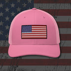 Pink cap with American flag patch on a distressed American flag background