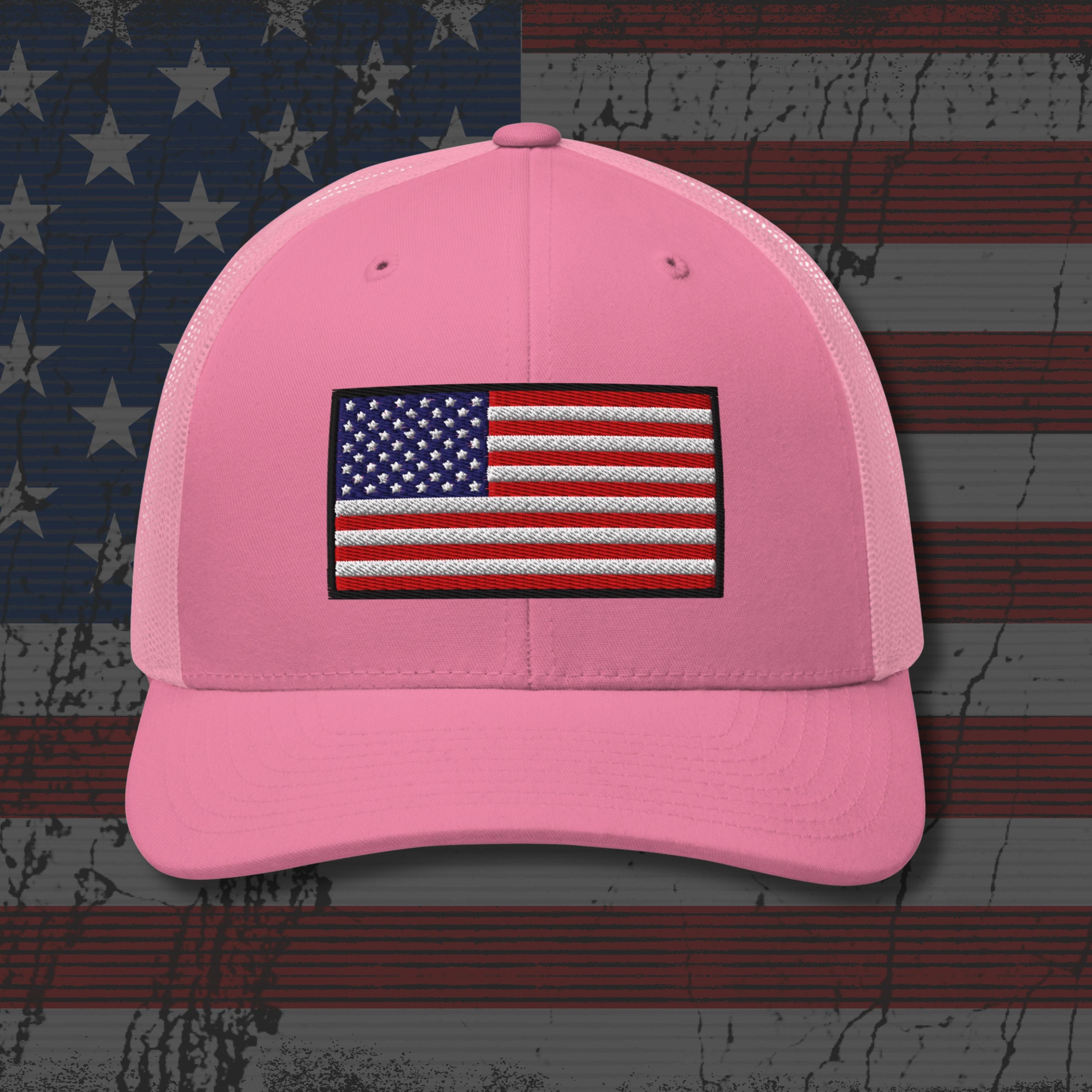 Pink cap with American flag patch on a distressed American flag background