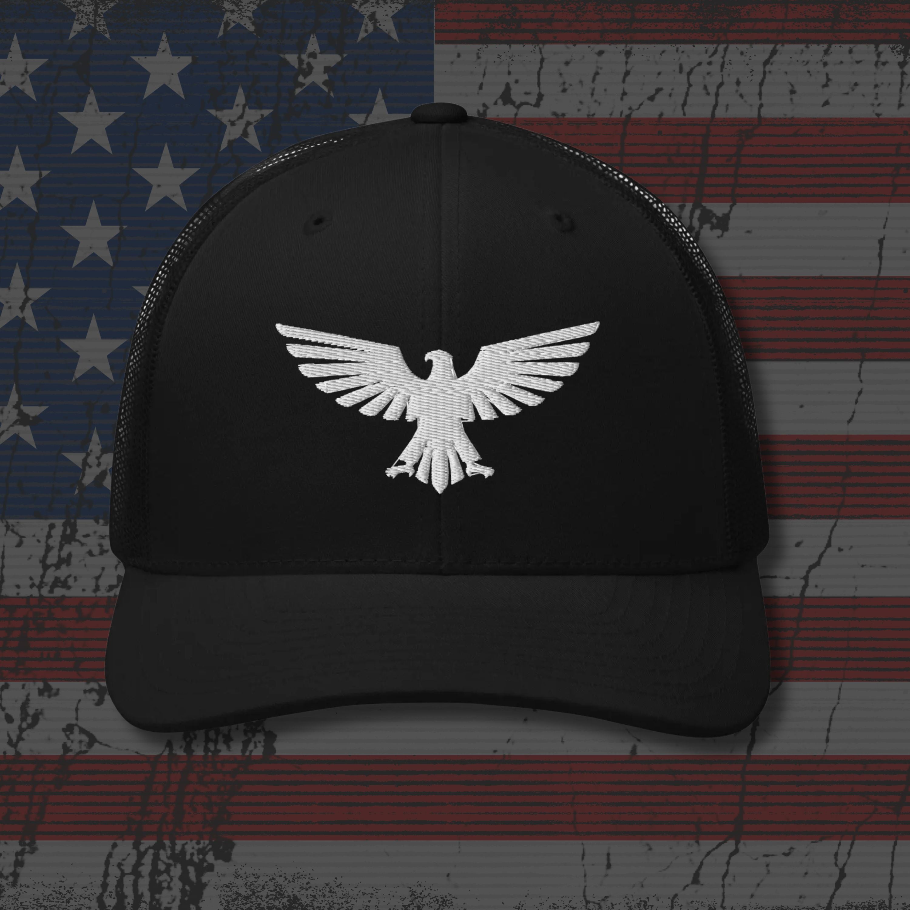 Black cap with white eagle emblem on an American flag background