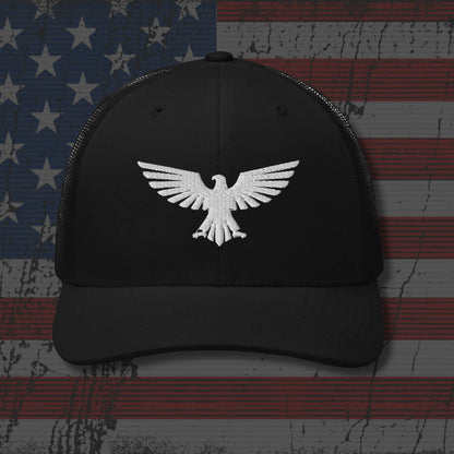 Black cap with white eagle emblem on an American flag background