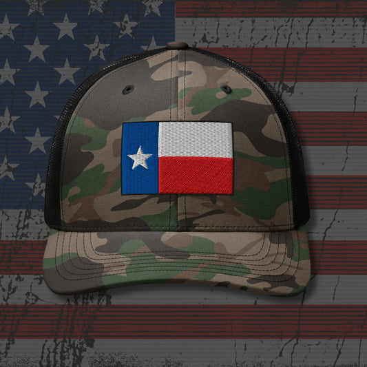 Camouflage cap with Texas flag patch on an American flag background