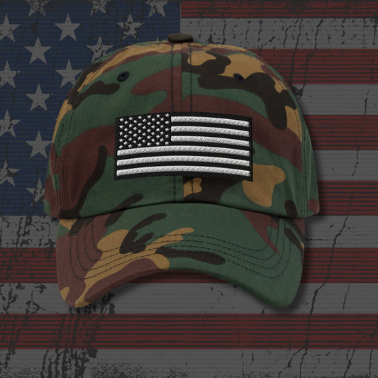 Camouflage baseball cap with American flag patch on an American flag background