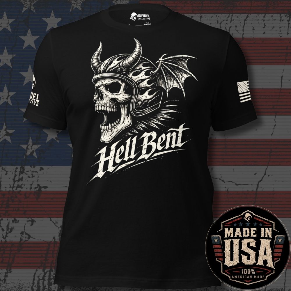 A black short-sleeve graphic T-shirt with a large white skull wearing a horned helmet and bat wings, with the text 'Hell Bent' across the front. The shirt is shown against a distressed American flag background, with a 'Made in USA' badge in the lower right corner.