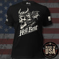 A black short-sleeve graphic T-shirt with a large white skull wearing a horned helmet and bat wings, with the text 'Hell Bent' across the front. The shirt is shown against a distressed American flag background, with a 'Made in USA' badge in the lower right corner.