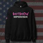 Black hoodie with 'SHITSHOW SUPERVISOR' text in pink and white on a textured background