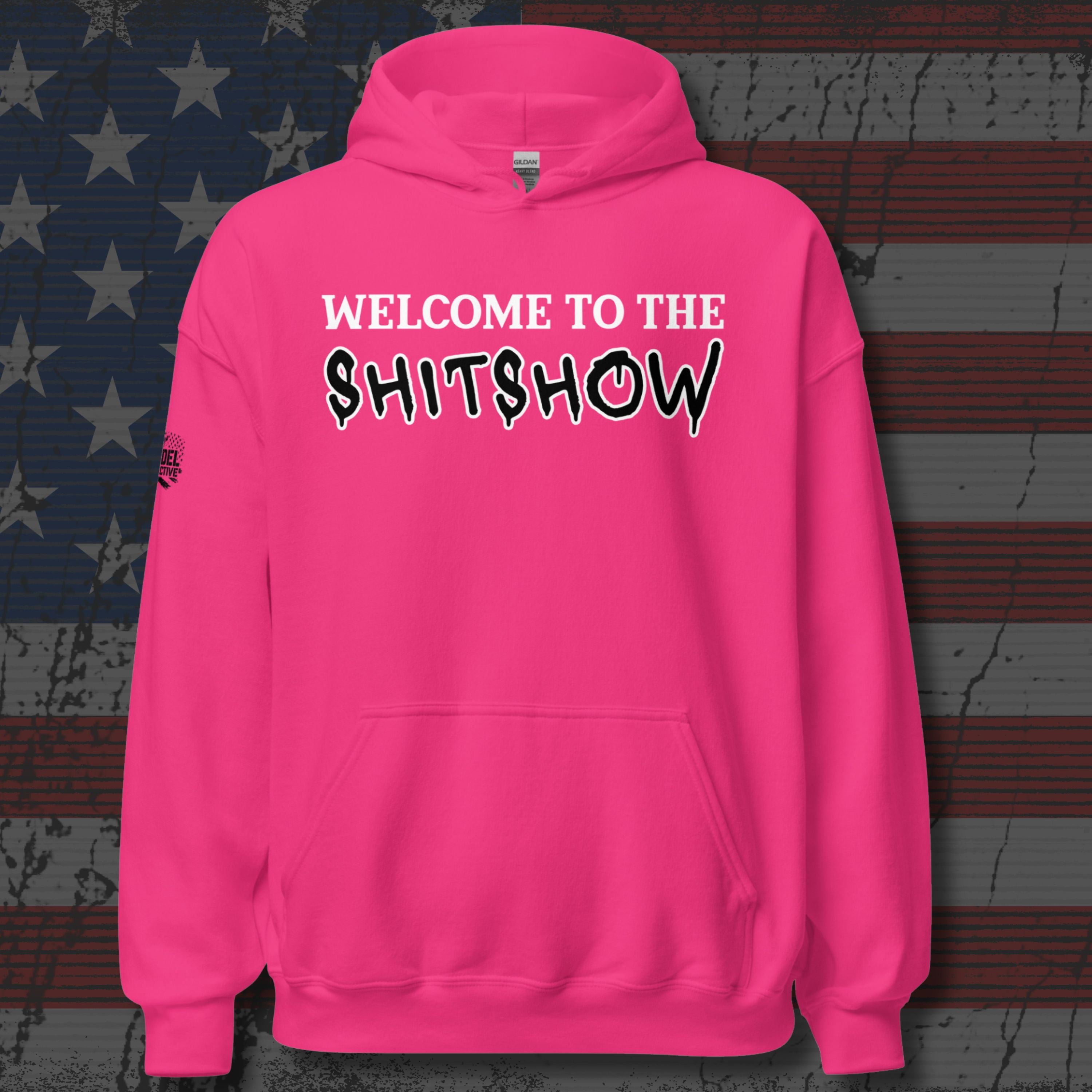 Pink hoodie with text 'WELCOME TO THE SHITSHOW' on a textured background