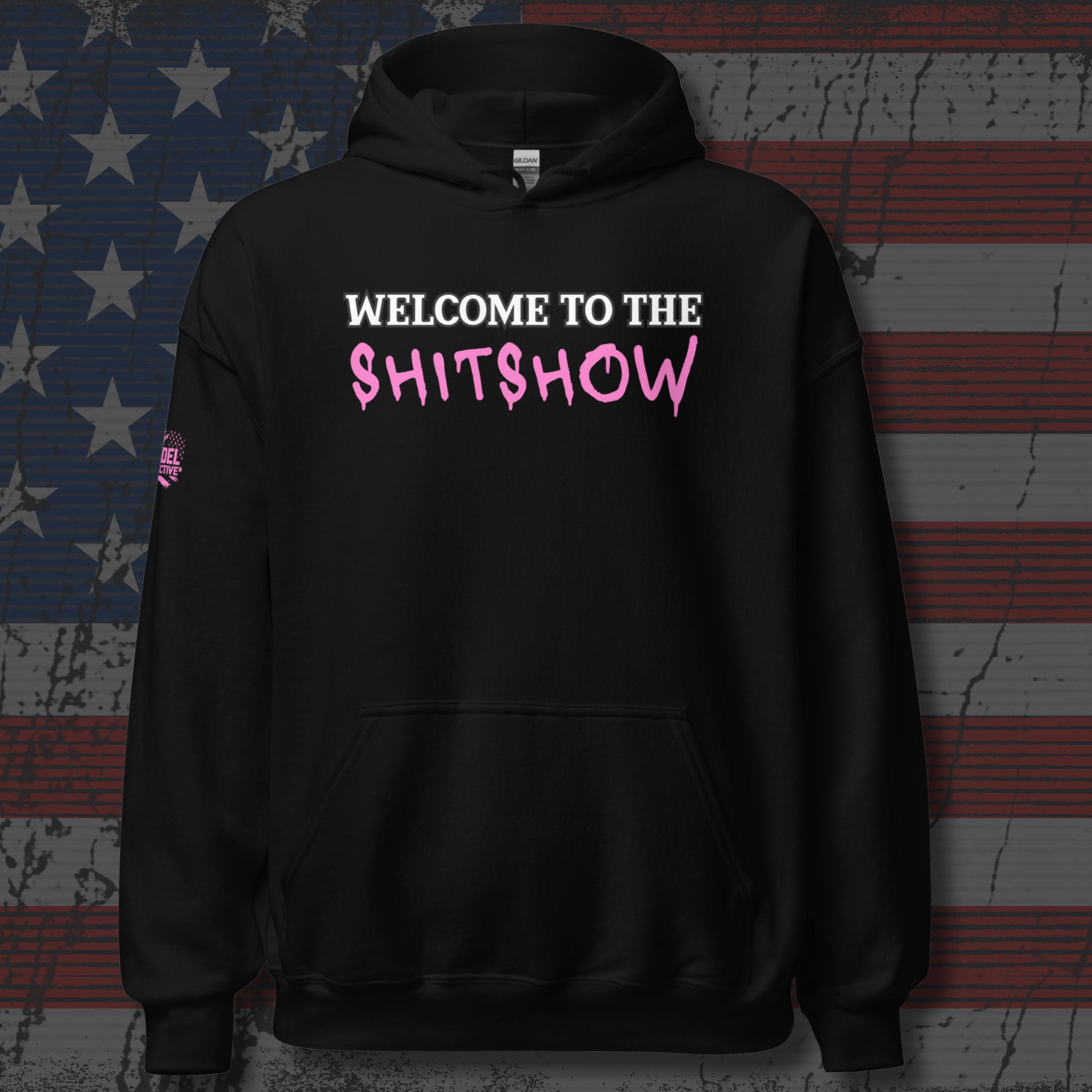 Black hoodie with 'Welcome to the Shitshow' i pink and white text on distressed American flag background