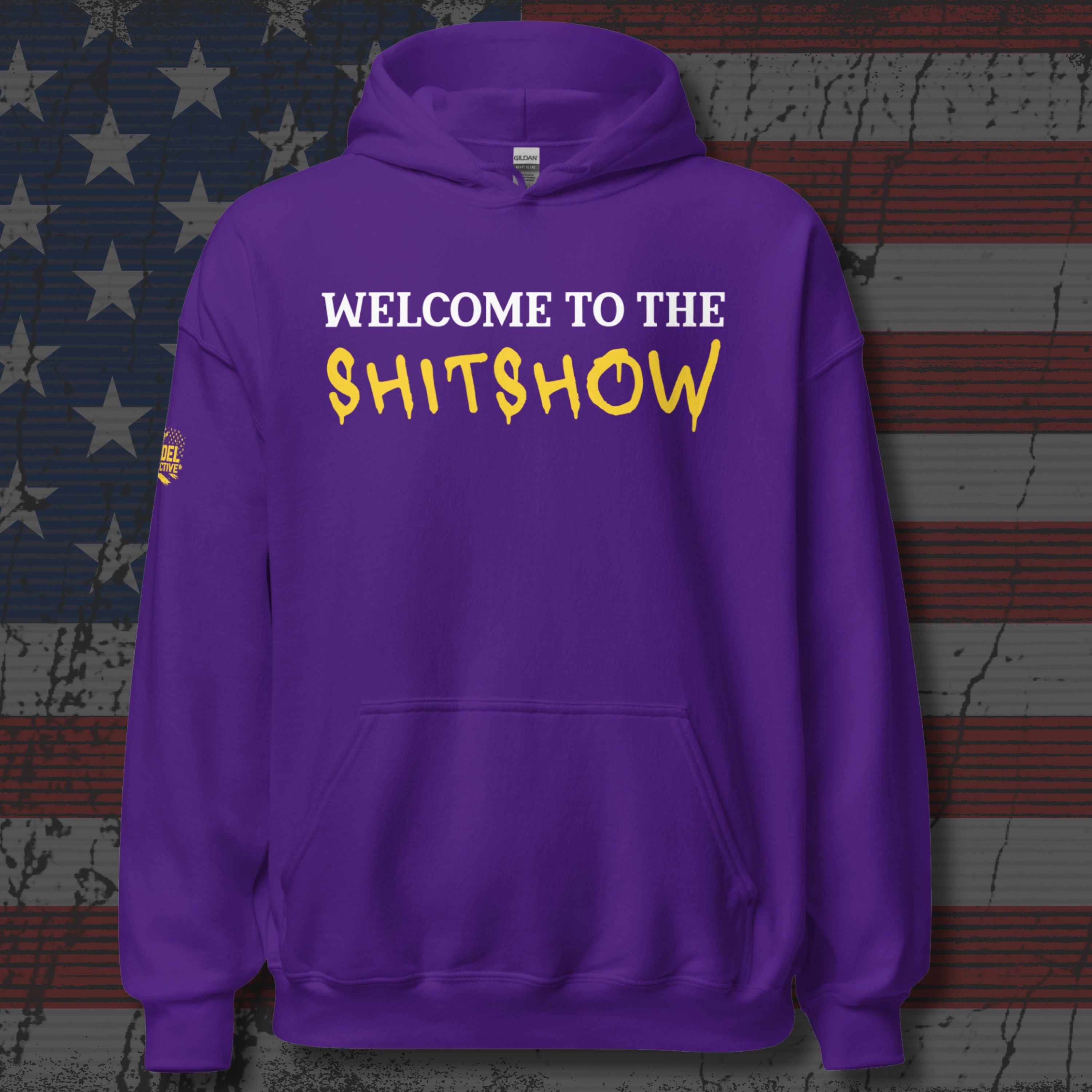 Purple hoodie with text 'WELCOME TO THE SHITSHOW' on a textured background